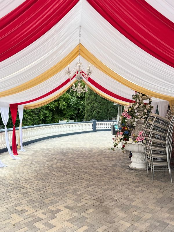 20x30 Canopy with Red and Gold Draping and Chandelier. 