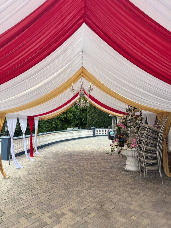 20x30 Canopy with Red and Gold Draping and Chandelier. 