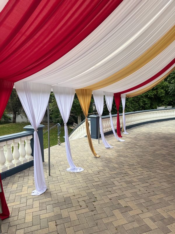20x30 Canopy with Red and Gold Draping and Chandelier. 