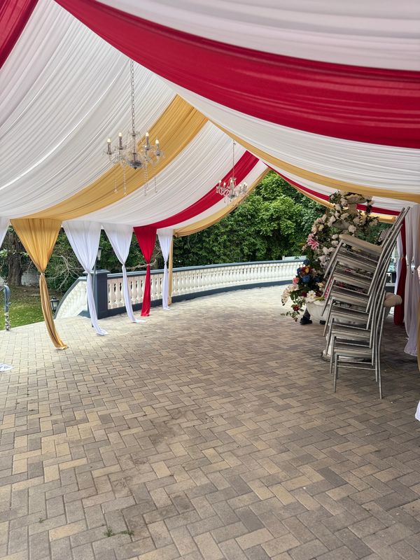 20x30 Canopy with Red and Gold Draping and Chandelier. 
