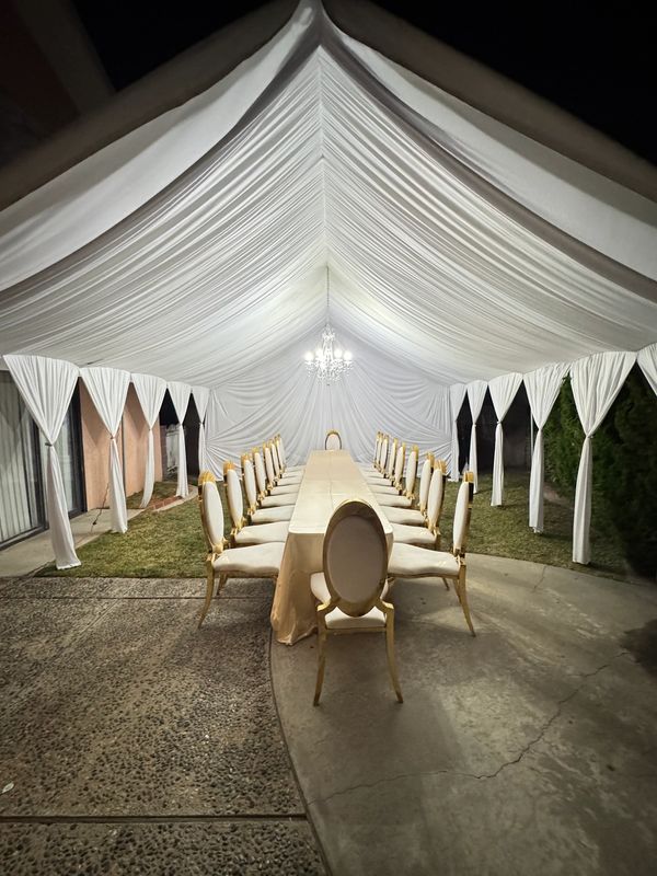 20x20 Tent with white draping fabrics and a chandelier. Fancy chairs provided by customer. Team work