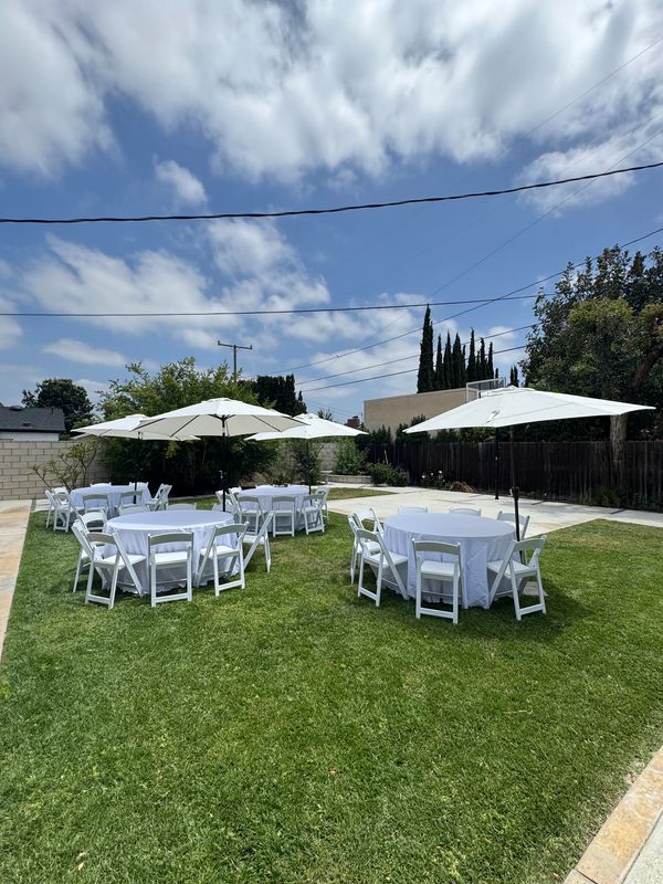 9' Umbrellas color white for shade. White tablecloths with 5' round tables that seat 8-10 persons. 