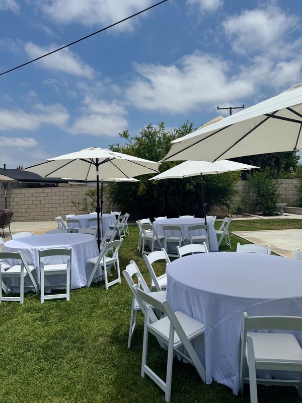 9' Umbrellas color white for shade. White tablecloths with 5' round tables that seat 8-10 persons. 