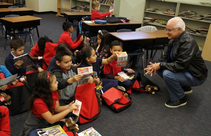 Faustino Bernadett and children reading.