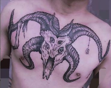 Black and grey goat skull chest tattoo by Amber Tattoos Ajax ON