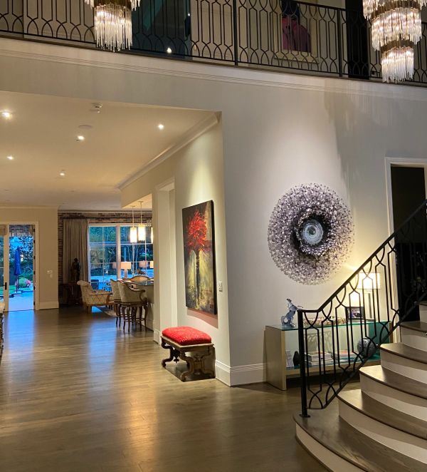 Elegant living space with chandelier and modern art.