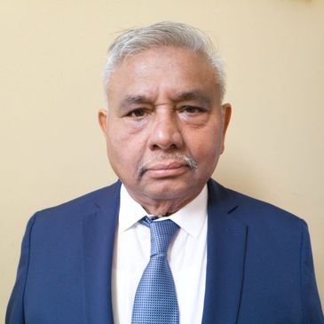 Portrait of an elderly man in a blue suit.