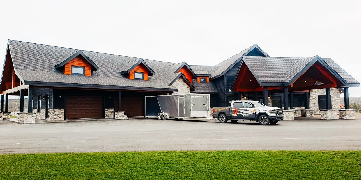 Image of Movers Nl Truck and trailer in front of customer's building