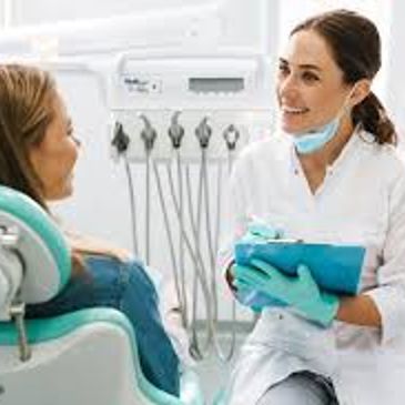 Dentist talking with a patient in a dental clinic.