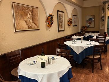 Cozy restaurant dining area with reserved tables and autumn decor.