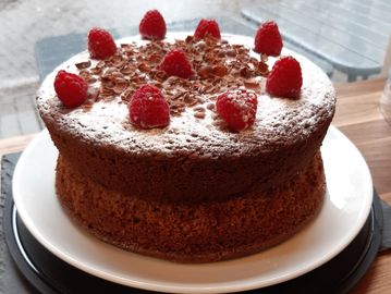 Delicious home-made Victoria Sponge cake topped with fresh Raspberries and Chocolate flakes. The centrepiece of today's cake table at Tea Traders tea shop. 