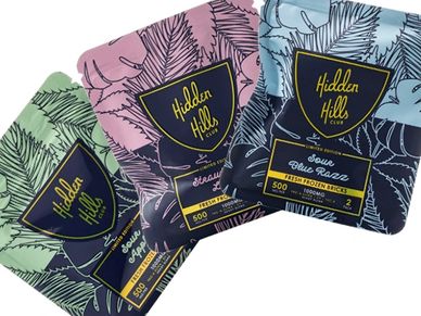 Colorful Hidden Hills Club cannabis packaging with leaf designs.