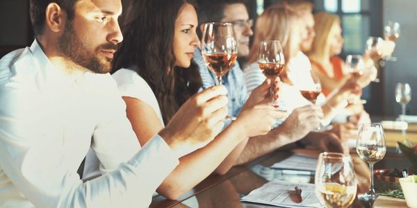 People attending a wine appreciation tasting.