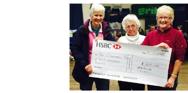 Gwen Davis (Chairman 2013 - 2016) presenting £800 pounds to The Cinnamon Trust in 2014
