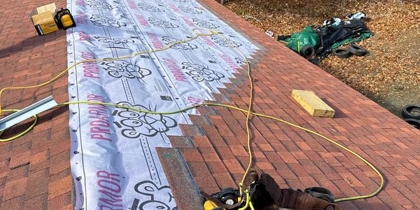Roof under construction with ProArmor underlayment and tools scattered.