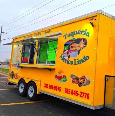 Bright yellow Mexican food truck with colorful logo and contact numbers.