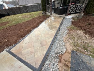 Newly paved stone walkway with gravel borders.