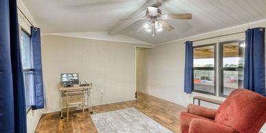 Photograph of a clean, well-lit living room for a listing for a home for sale in Sayre, OK.