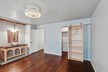 Western Oklahoma real estate photographer took photo of a bedroom w/closet hidden behind a bookcase