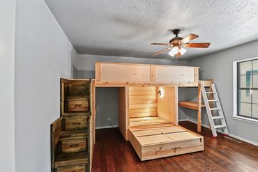 Western OK real estate photographer's photo of  boy's bedroom with built in captain bed and storage