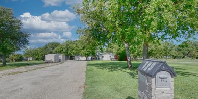 Street view of a drive leading to the front door of a lakeside home near Graham, TX