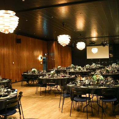Elegant banquet hall with round tables set for a formal event.