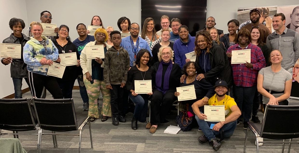 Group photo with certificates after a training or event.