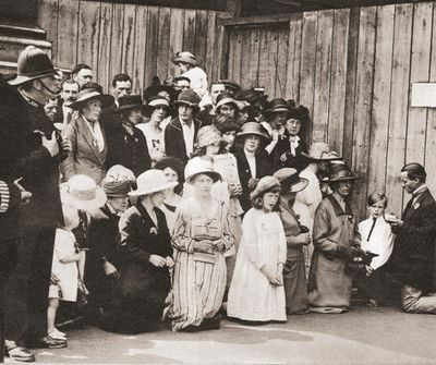 Irish men, women and children on their knees praying in Downing Street during the negotiations. 