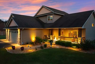 A cozy house with warm outdoor lighting at dusk.