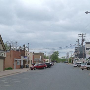 A quiet street in a small town on a cloudy day.