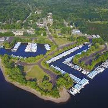 Aerial view of a marina with boats docked along the shoreline.