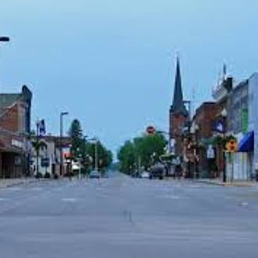 Empty street in a small town with a church steeple.