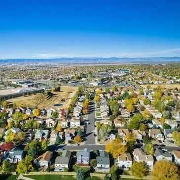 Aerial view of a suburban neighborhood with houses and trees.