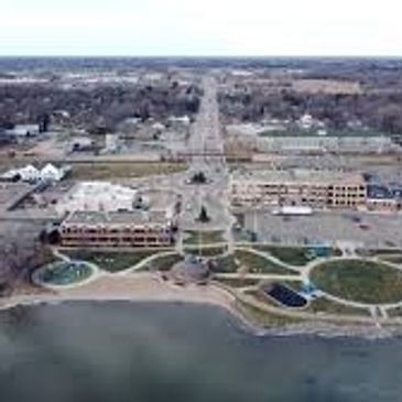 A waterfront area with buildings and a road extending into the distance.