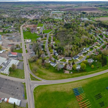 Aerial view of a suburban neighborhood with winding streets and green spaces.