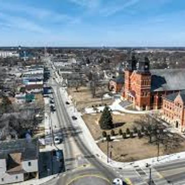 Aerial view of a town with a large church and surrounding streets.