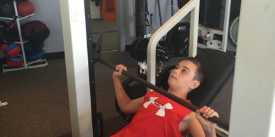young athlete doing chest press