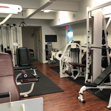 bright, clean, fully equipped fitness studio with weights and cardio machines