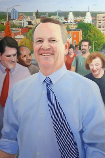 A smiling man in a blue shirt and striped tie stands in front of a cityscape with several people behind him.