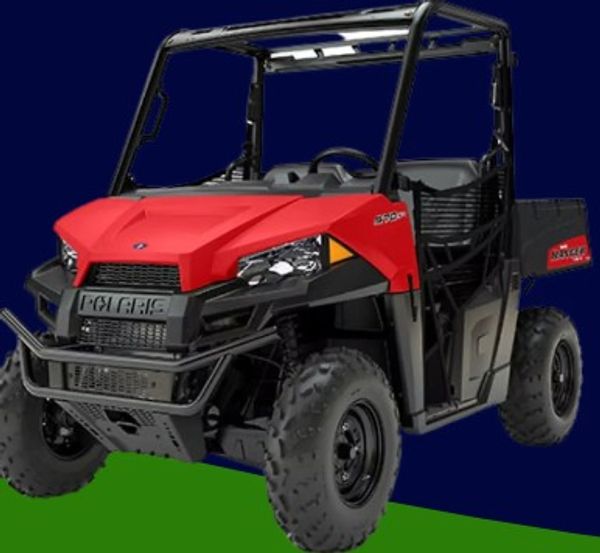Red Polaris off-road utility vehicle with rugged tires and protective frame.