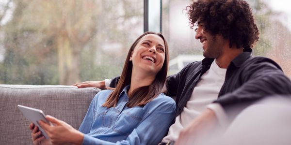 relaxed-young-couple-at-home-lying-on-sofa