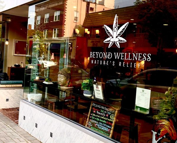 Beyond Wellness offering THC and CBD products with a serene Buddha statue inside.