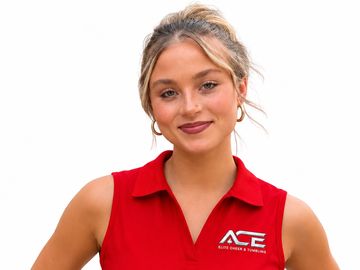 Smiling woman wearing a red sleeveless polo with ACE logo.