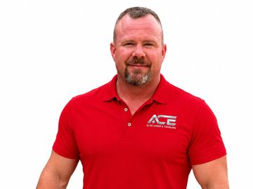 A man wearing a red ACE Auto Glass &amp; Tinting polo shirt.