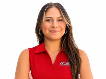 Smiling woman in red sleeveless shirt with logo on white background.