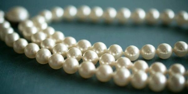 A classic pearl necklace elegantly displayed, showcasing timeless beauty and sophistication