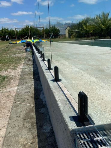 Glass pool fence with black spigots