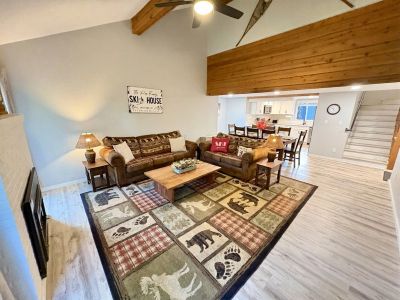 Cozy rustic living room with bear-themed decor and wooden accents.