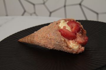 Cheesecake in a cone with strawberries