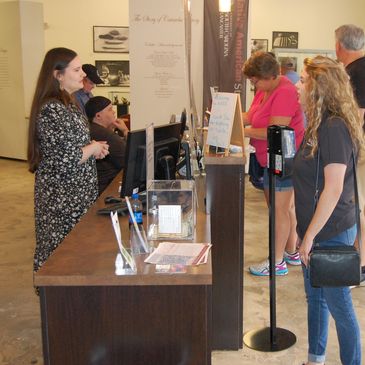 Kaitlyn Shull and Crystal Angel-Melton assist visitors.